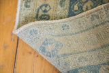 Vintage Afshar rug's hand-knotted foundation, showing tight weave with aqua and tan geometric patterns.
