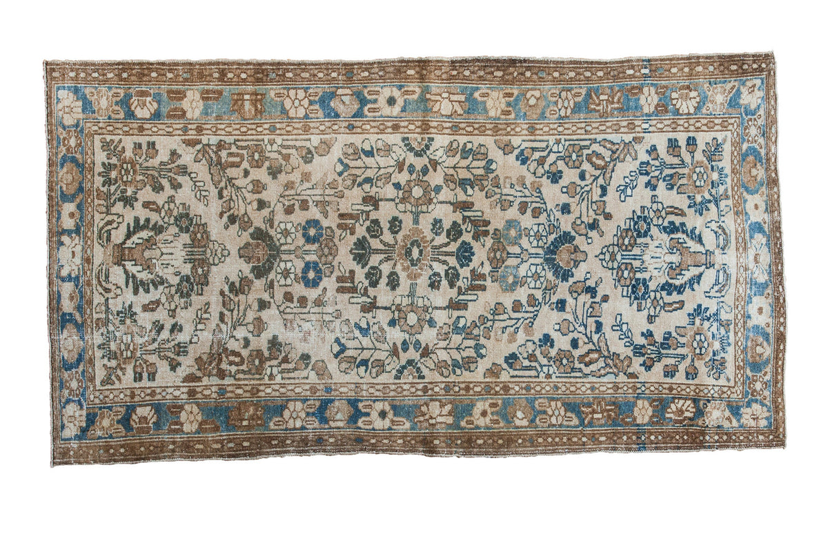 Vintage distressed Lilihan rug with ivory field, blue and brown borders, floral bouquets.