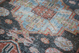 Distressed Malayer runner texture, revealing faded denim blue, soft blue, and brick red motifs.