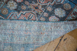 Vintage Malayer runner, revealing hand-knotted back, blue overcast edge, and distressed pile.