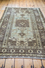 Stylized geometric motifs on a 1960s Turkish Oushak rug in seafoam and bronze.