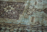 Vintage Oushak rug detail: stylized geometric motif in seafoam, silver, and bronze.