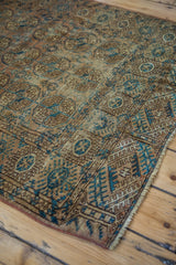 Distressed fine weave Turkmen Bokhara rug with striking turquoise and tan patterns.