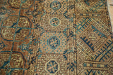 Fine weave detail of a distressed Turkmen Bokhara rug with brown and teal geometry.