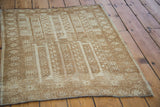 Vintage Belouch rug, geometric design of ivory and golden bronze elongated animal figures.