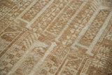 Hand-knotted pile of vintage Belouch rug with geometric motifs in ivory and golden bronze.