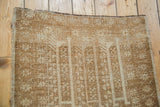 Textured pile of the vintage Belouch rug, showing geometric ivory and golden bronze design.