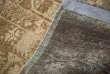 Textured golden bronze pile and tight dark brown hand-knotted foundation of a vintage Belouch rug.