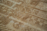 Hand-knotted pile detail of vintage Belouch rug, geometric design in deep bronze and ivory.