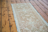 Low pile texture of a vintage Persian Karaja runner with ivory, bronze, and coral geometric pattern.