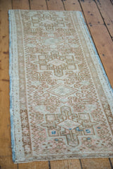 Vintage Karaja runner's low pile ivory field with decorative coral and bronze geometric motifs.