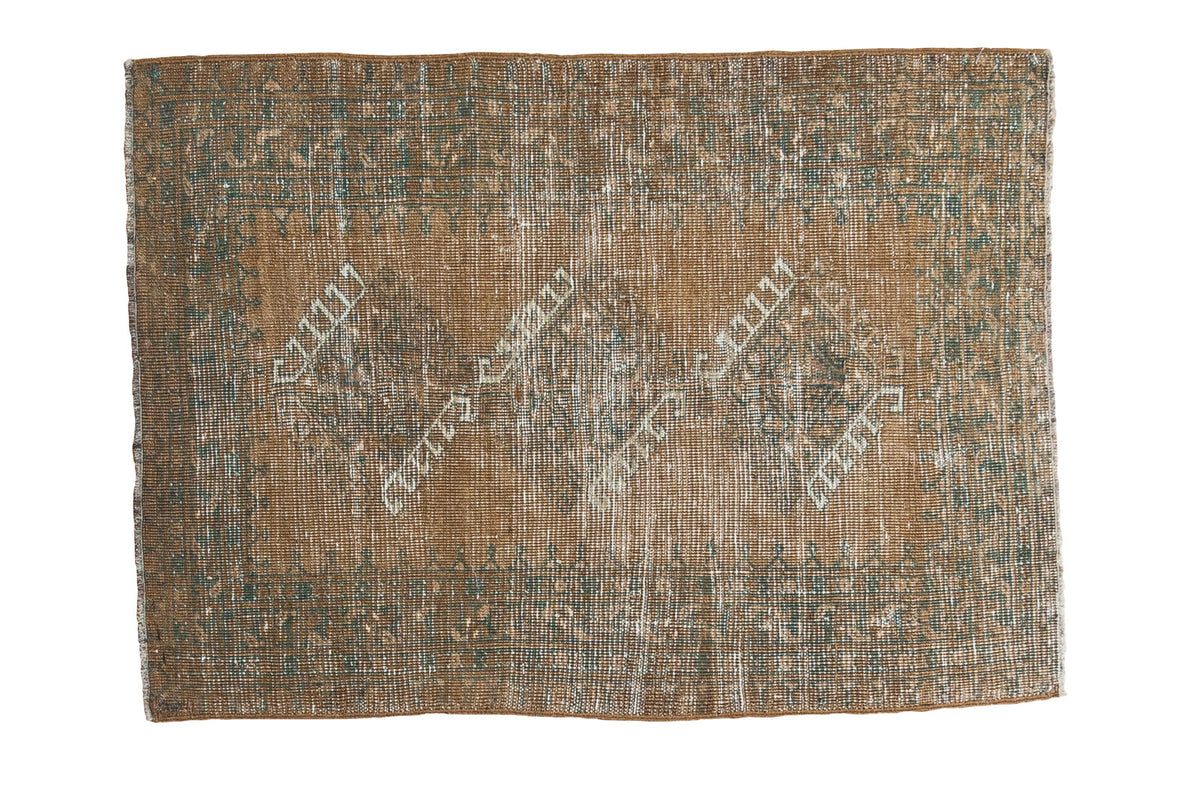 Distressed Afghan rectangular rug, faded copper field with triple gul medallions and teal ivory.