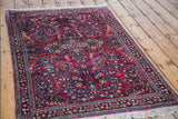 Vintage Sarouk rug's intricate blossoming floral motifs on a jewel red field and border.