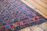 Vintage Bidjar rug's bright coral rose border with unique green accents and navy field.