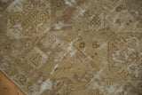 Distressed vintage Oushak rug texture, faded bronze, ivory, with scrolling wave border.