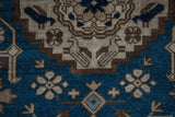 Antique Caucasian rug detail: stylized birds and arabesques on deep indigo with beige.
