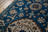 Antique Caucasian rug detail with deep indigo field, stylized arabesque and geometric motifs.