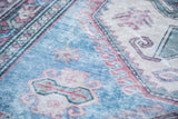 Distressed low bristly pile of a Caucasian rug with brilliant blue geometric motifs.