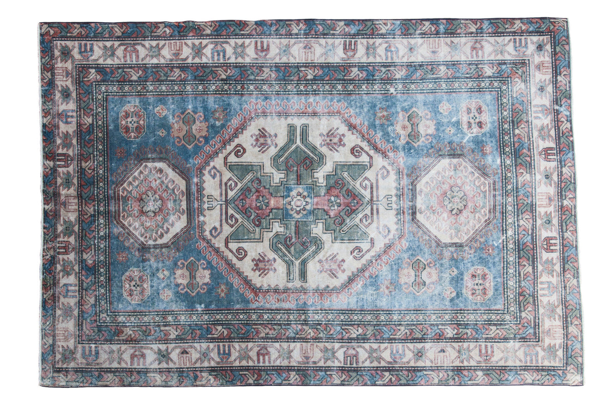 Distressed vintage Caucasian carpet with popping brilliant blue and geometric design, 4'10" x 7'.
