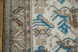 Textured distressed Mehraban rug with brilliant indigo trefoil motifs and earth-toned serrated leaves.
