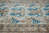 Distressed vintage Mehraban rug with indigo and earth-toned trefoil motifs.