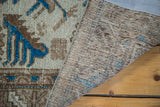 Distressed pile texture and indigo motifs of Mehraban rug, revealing woven foundation.