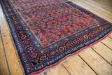 Vibrant Herati pattern and floral border of an antique Persian Bidjar rug with striking green tones.