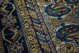 Textured pile detail of an antique Feraghan rug with indigo, gold, and subtle paisley motifs.