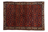 Antique Persian Engelas rug features rich ruby red field and intricate navy herati design with ivory borders.