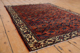 Intricate Herati design on an antique Engelas rug, deep terra cotta and sapphire blue.