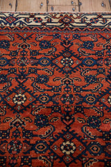 Exquisite Herati motif in brilliant rust and navy on soft wool of antique Persian Engelas rug.