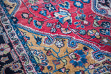 Fine detailed ornamentation of vintage Josan Sarouk rug in cranberry red, gold, and blue.