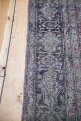 Distressed texture and faded curvilinear patterns of the vintage Sivas carpet.