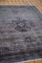 Vintage Sivas carpet featuring textural distressed pile and faded curvilinear motifs.
