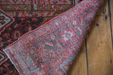 Back of vintage Persian Malayer rug showing the hand-knotted construction and finished edge.