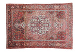 Vintage Persian Malayer rug with a large ivory medallion on an abrashed field of charcoal, mauve, and silver.