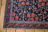 Antique Afshar rug corner: deep blue field, cinnabar Guli Hannai, ivory, and detailed boteh border.