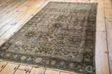 Vintage Malayer rug's bronze and ivory field with aqua teal star and samovar motifs.