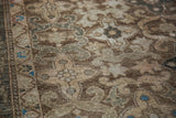 Textured vintage Malayer rug pile displaying abrashes, bronzes, ivory, and aqua teal patterns.