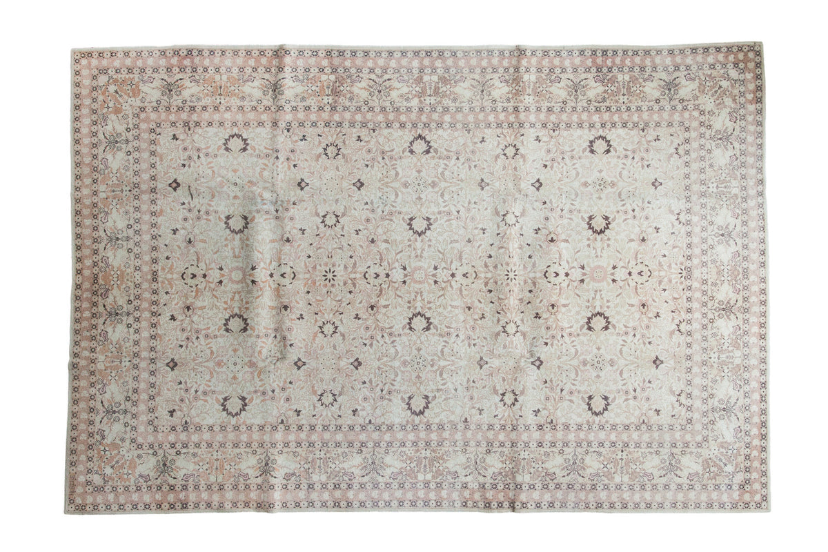 Distressed vintage Hereke carpet with allover palmettes and vines in soft ivory and muted pink, 6'10" x 10'3".