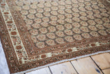 Antique Tabriz rug showcasing exquisite repeating botehs on a silver-toned field.