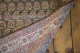 Antique Tabriz rug's hand-knotted back and detailed red, gold paisley boteh pile.