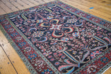 Large-scale expressive floral and scrolling vine motifs in brilliant tones on vintage Bakhtiari.