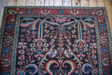 Antique Bakhtiari carpet's dramatic floral style and brilliant jewel tones on dark ground.