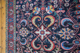 Vibrant floral and geometric patterns visible in this antique Baktiari carpet detail.
