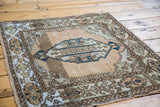 Soft, distressed vintage Sivas rug showing coral, bronze abrasions, and blue lozenge medallion.