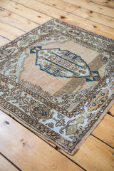 Distressed corner of the vintage Sivas rug, showing abrashed coral, bronze, and blue tones.
