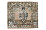 Distressed vintage Sivas rug with coral abrashed field and blue lozenge medallion.