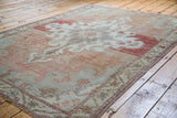 Textured pile of Distressed Oushak carpet with sun-kissed cinnabar red abrashed field.