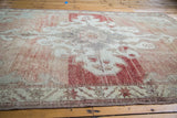 Distressed vintage Oushak carpet texture with sun-kissed cinnabar red and soft grey abrash.